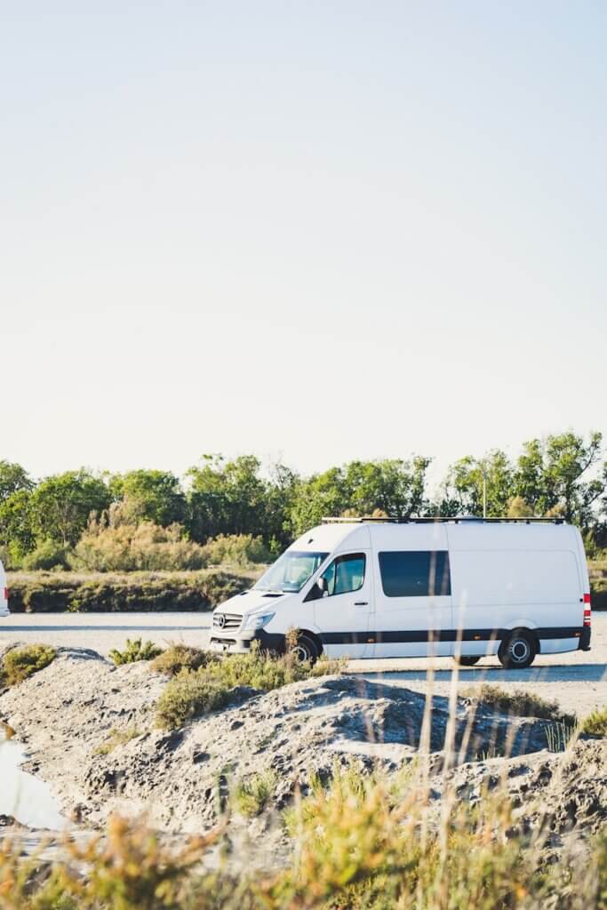 white van on gray concrete road during daytime